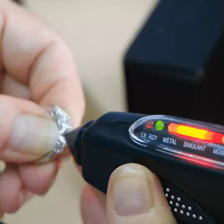 Picture of a black hand-held diamond tester