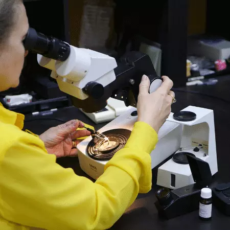 Picture of gemmology instructor, Tanja Sadow, using the microscope