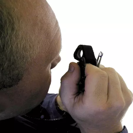 A person looking through a jeweller's loupe