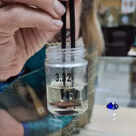 Picture of instructor Tanja putting a gem into gravity liquids